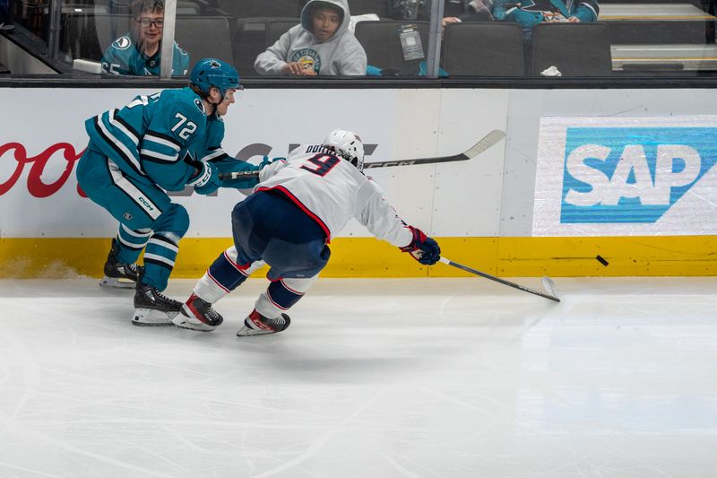 Nov 5, 2024; San Jose, California, USA;  San Jose Sharks left wing William Eklund (72) and Columbus Blue Jackets defenseman Ivan Provorov (9) battle for the puck on the boards during the third period at SAP Center at San Jose. Mandatory Credit: Neville E. Guard-Imagn Images