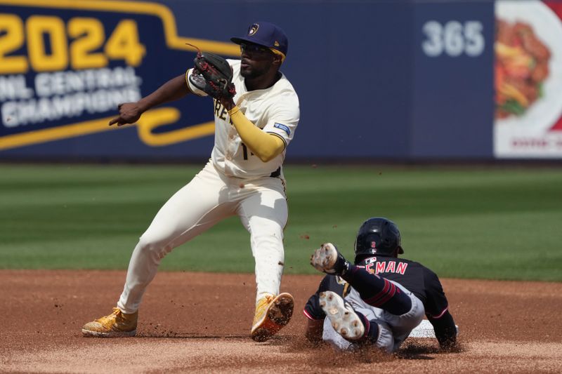 Mar 16, 2025; Phoenix, Arizona, USA; Milwaukee Brewers third base Andruw Monasterio (14) tries to tag Cleveland Guardians outfielder Tyler Freeman (2) in the first inning at American Family Fields of Phoenix. Mandatory Credit: Rick Scuteri-Imagn Images