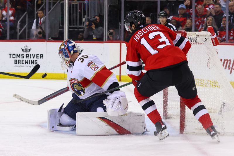 Jan 14, 2025; Newark, New Jersey, USA; Florida Panthers goaltender Spencer Knight (30) makes a save on New Jersey Devils center Nico Hischier (13) during the second period at Prudential Center. Mandatory Credit: Ed Mulholland-Imagn Images