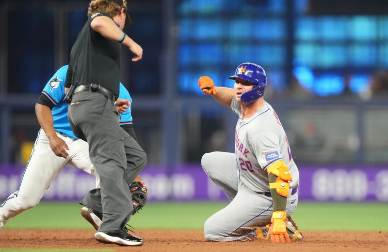 May 19, 2024; Miami, Florida, USA;  New York Mets first baseman Pete Alonso (20) slides into second base with a double in the second inning against the Miami Marlins at loanDepot Park. Mandatory Credit: Jim Rassol-USA TODAY Sports