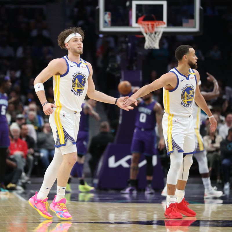 CHARLOTTE, NC - MARCH 3: Brandin Podziemski #2 and Stephen Curry #30 of the Golden State Warriors high five during the game against the Charlotte Hornets on March 3, 2025 at Spectrum Center in Charlotte, North Carolina. NOTE TO USER: User expressly acknowledges and agrees that, by downloading and or using this photograph, User is consenting to the terms and conditions of the Getty Images License Agreement. Mandatory Copyright Notice: Copyright 2025 NBAE (Photo by Brock Williams-Smith/NBAE via Getty Images)