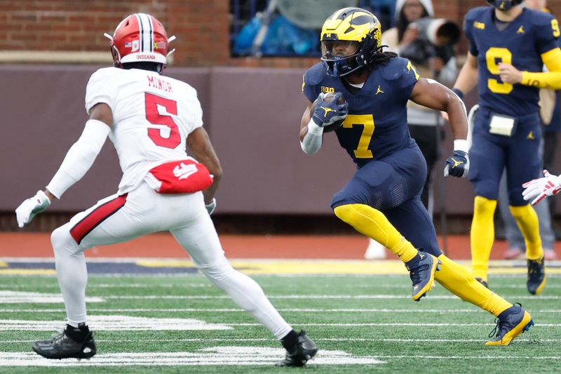 Oct 14, 2023; Ann Arbor, Michigan, USA; Michigan Wolverines running back Donovan Edwards (7) rushes in the first half against the Indiana Hoosiers at Michigan Stadium. Mandatory Credit: Rick Osentoski-USA TODAY Sports