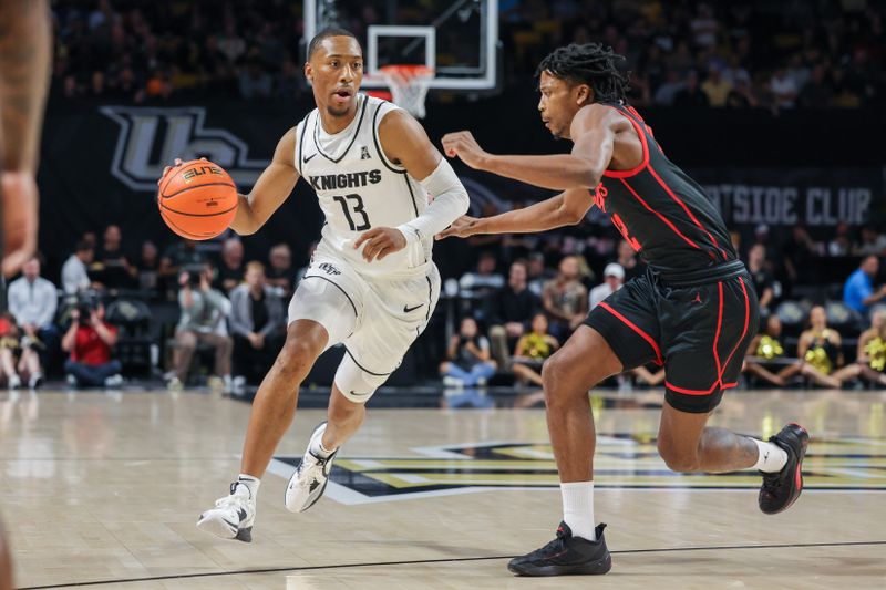 Jan 25, 2023; Orlando, Florida, USA; UCF Knights guard C.J. Kelly (13) drives to the basket against Houston Cougars guard Tramon Mark (12) during the first half at Addition Financial Arena. Mandatory Credit: Mike Watters-USA TODAY Sports