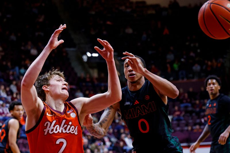 Jan 4, 2025; Blacksburg, Virginia, USA; Virginia Tech Hokies guard Jaden Schutt (2) loses the ball against Miami Hurricanes guard Matthew Cleveland (0) during the first half at Cassell Coliseum. Mandatory Credit: Peter Casey-Imagn Images
