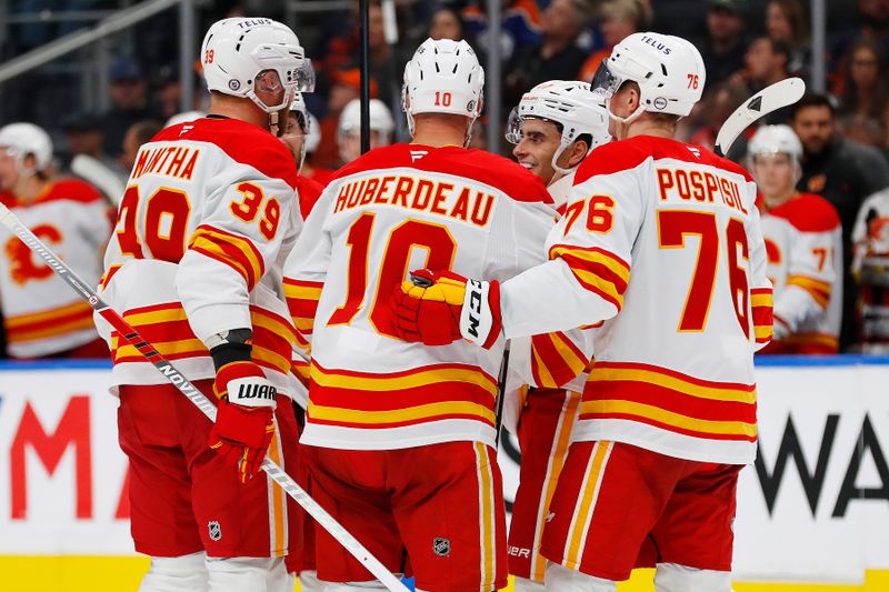 Sep 23, 2024; Edmonton, Alberta, CAN; The Calgary Flames celebrate a goal by defensemen Rasmus Andersson (4) during the second period against the Edmonton Oilers at Rogers Place. Mandatory Credit: Perry Nelson-Imagn Images