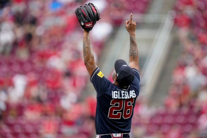 Jun 25, 2023; Cincinnati, Ohio, USA; Atlanta Braves relief pitcher Raisel Iglesias (26) celebrates the win at the conclusion of a baseball game against the Cincinnati Reds at Great American Ball Park. The Atlanta Braves won, 7-6. Mandatory Credit: Kareem Elgazzar-USA TODAY Sports