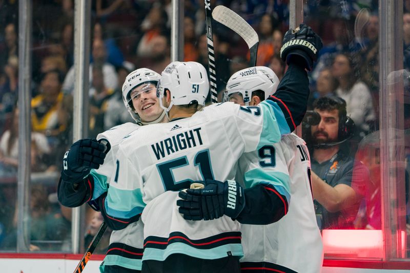 Sep 29, 2022; Vancouver, British Columbia, CAN; Seattle Kraken forward Ryan Donato (9) and forward Shane Wright (51) and forward Tye Kartye (52) celebrate Kartye   s goal against the Vancouver Canucks in the first period at Rogers Arena. Mandatory Credit: Bob Frid-USA TODAY Sports