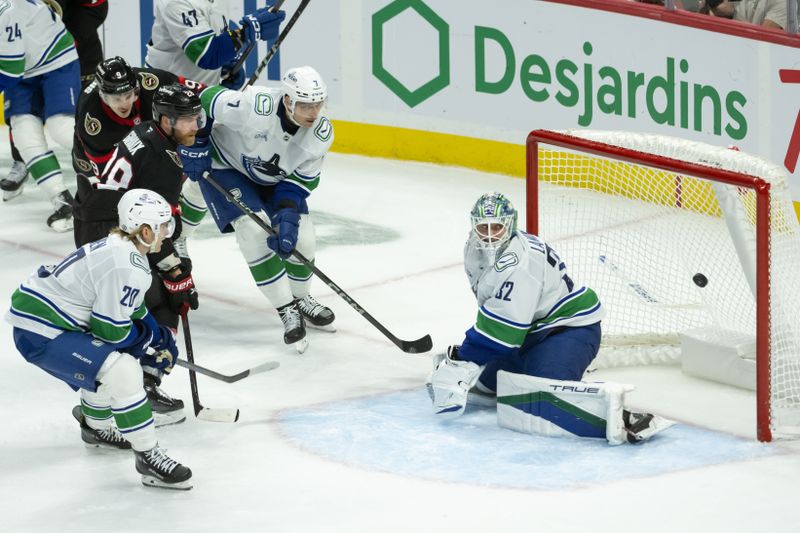 Nov 23, 2024; Ottawa, Ontario, CAN; Ottawa Senators right wing Claude Giroux (28) scores against Vancouver Canucks goalie Kevin Lankine (32) in the third period at the Canadian Tire Centre. Mandatory Credit: Marc DesRosiers-Imagn Images