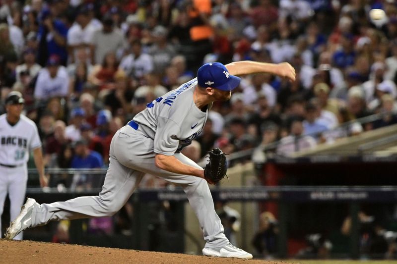 Oct 11, 2023; Phoenix, Arizona, USA; Los Angeles Dodgers relief pitcher Caleb Ferguson (64) throws a pitch against the Arizona Diamondbacks in the fourth inning for game three of the NLDS for the 2023 MLB playoffs at Chase Field. Mandatory Credit: Matt Kartozian-USA TODAY Sports