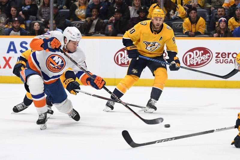 Jan 13, 2024; Nashville, Tennessee, USA; New York Islanders left wing Matt Martin (17) shoots the puck during the second period against the Nashville Predators at Bridgestone Arena. Mandatory Credit: Christopher Hanewinckel-USA TODAY Sports