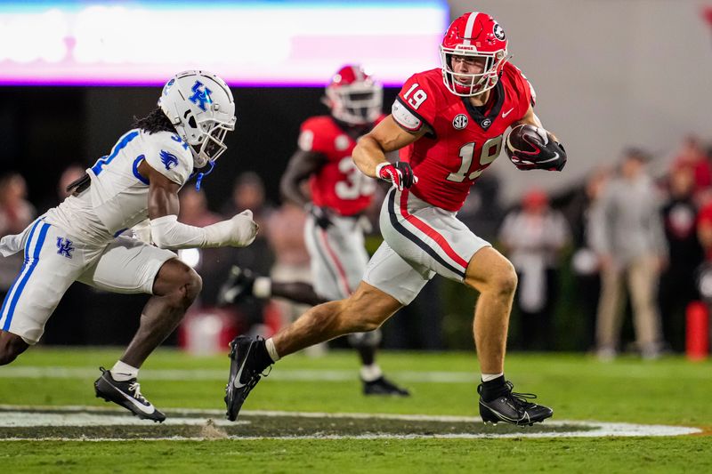 Oct 7, 2023; Athens, Georgia, USA; Georgia Bulldogs tight end Brock Bowers (19) runs against Kentucky Wildcats defensive back Maxwell Hairston (31) after after a catch during the first quarter at Sanford Stadium. Mandatory Credit: Dale Zanine-USA TODAY Sports