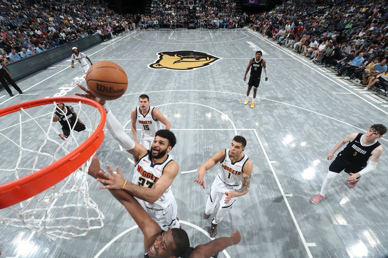 MEMPHIS, TN - APRIL 14:  Jamal Murray #27 of the Denver Nuggets drives to the basket during the game against the Memphis Grizzlies on April 14, 2024 at FedExForum in Memphis, Tennessee. NOTE TO USER: User expressly acknowledges and agrees that, by downloading and or using this photograph, User is consenting to the terms and conditions of the Getty Images License Agreement. Mandatory Copyright Notice: Copyright 2024 NBAE (Photo by Joe Murphy/NBAE via Getty Images)