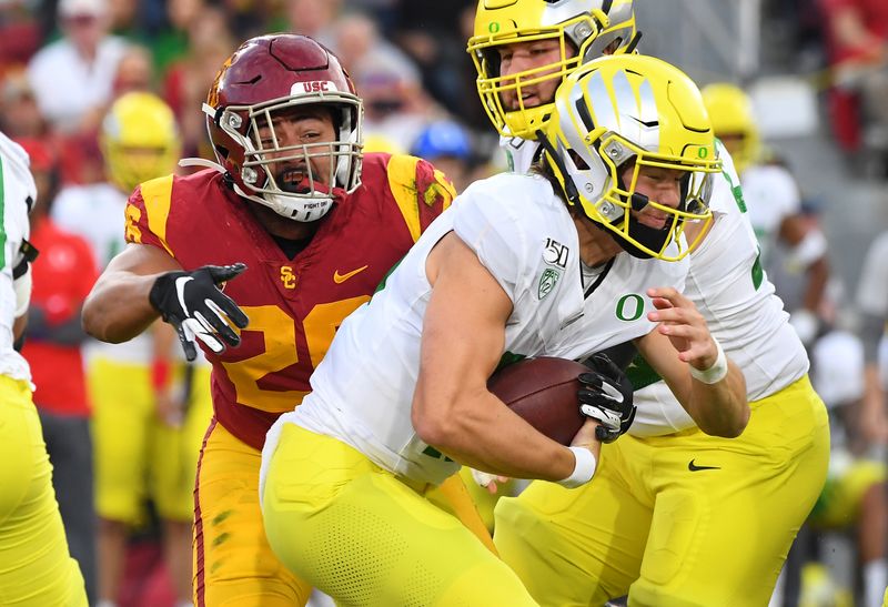 Nov 2, 2019; Los Angeles, CA, USA;  USC Trojans linebacker Kana'i Mauga (26) sacks  Oregon Ducks quarterback Justin Herbert (10) in the first quarter of the game against the Oregon Ducks at Los Angeles Memorial Coliseum. Mandatory Credit: Jayne Kamin-Oncea-USA TODAY Sports