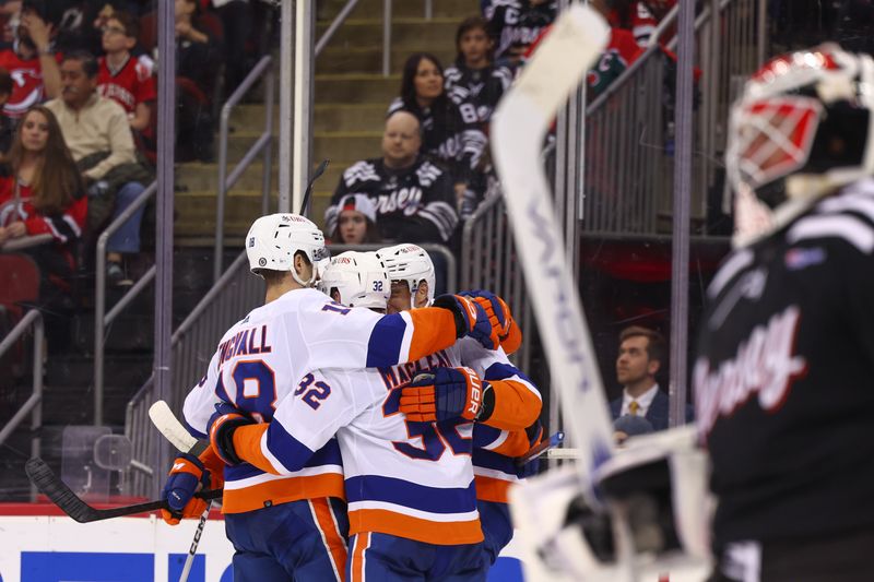 Apr 15, 2024; Newark, New Jersey, USA; New York Islanders center Kyle MacLean (32) celebrates his goal against the New Jersey Devils during the third period at Prudential Center. Mandatory Credit: Ed Mulholland-USA TODAY Sports