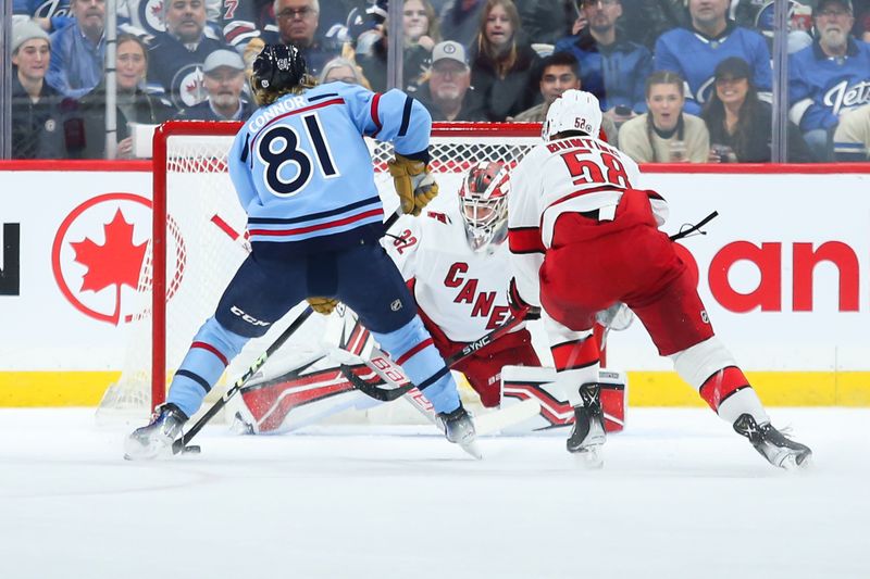 Dec 4, 2023; Winnipeg, Manitoba, CAN; Winnipeg Jets forward Kyle Connor (81) scores on Carolina Hurricanes goalie Antti Raanta (32) during the first period at Canada Life Centre. Mandatory Credit: Terrence Lee-USA TODAY Sports