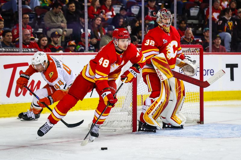 Jan 25, 2026; Calgary, Alberta, CAN; Calgary Flames defenseman Hunter Brzustewicz (48) controls the puck against the Anaheim Ducks during the third period at Scotiabank Saddledome. Mandatory Credit: Sergei Belski-Imagn Images