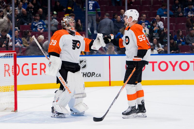 Dec 28, 2023; Vancouver, British Columbia, CAN; Philadelphia Flyers defenseman Rasmus Ristolainen (55) and goalie Carter Hart (79) celebrate their victory against the Vancouver Canucks at Rogers Arena. Flyers won 4-1. Mandatory Credit: Bob Frid-USA TODAY Sports