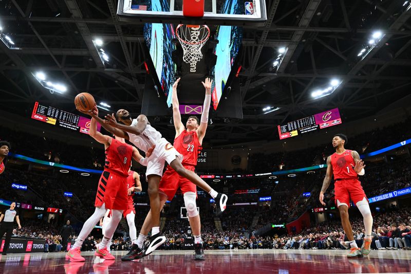 CLEVELAND, OHIO - MARCH 02: Evan Mobley #4 of the Cleveland Cavaliers shoots over Deni Avdija #8 and Donovan Clingan #23 of the Portland Trail Blazers during the fourth quarter at Rocket Arena on March 02, 2025 in Cleveland, Ohio. The Cavaliers defeated the Trail Blazers 133-129. NOTE TO USER: User expressly acknowledges and agrees that, by downloading and or using this photograph, User is consenting to the terms and conditions of the Getty Images License Agreement. (Photo by Jason Miller/Getty Images)