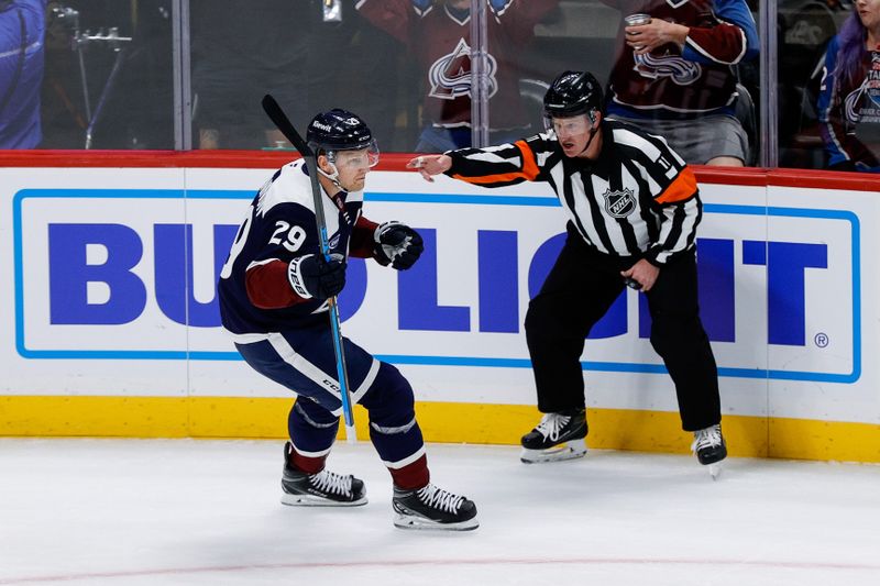 Oct 28, 2024; Denver, Colorado, USA; Colorado Avalanche center Nathan MacKinnon (29) celebrates after his goal as referee Kelly Sutherland (11) gestures towards the net in the first period against the Chicago Blackhawks at Ball Arena. Mandatory Credit: Isaiah J. Downing-Imagn Images