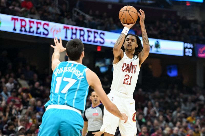 CLEVELAND, OHIO - APRIL 14: Emoni Bates #21 of the Cleveland Cavaliers shoots a three-point basket against Aleksej Pokusevski #17 of the Charlotte Hornets during the first half at Rocket Mortgage Fieldhouse on April 14, 2024 in Cleveland, Ohio. NOTE TO USER: User expressly acknowledges and agrees that, by downloading and or using this photograph, User is consenting to the terms and conditions of the Getty Images License Agreement. (Photo by Nick Cammett/Getty Images)