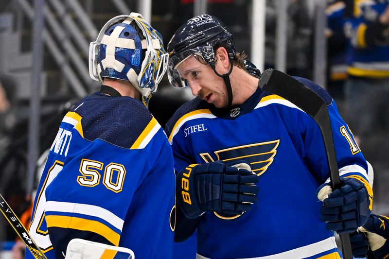 Nov 3, 2023; St. Louis, Missouri, USA;  St. Louis Blues center Kevin Hayes (12) celebrates with goaltender Jordan Binnington (50) after the Blues defeated the New Jersey Devils at Enterprise Center. Mandatory Credit: Jeff Curry-USA TODAY Sports