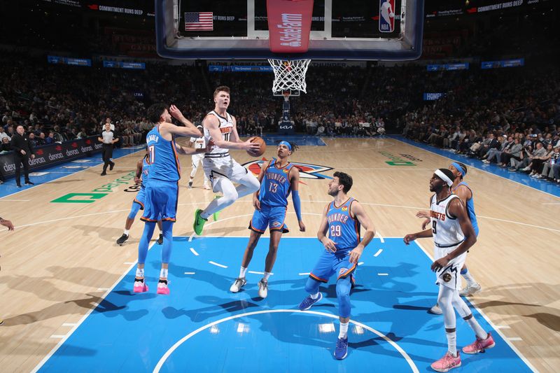 OKLAHOMA CITY, OK - JANUARY 31: Christian Braun #0 of the Denver Nuggets drives to the basket during the game against the Oklahoma City Thunder on January 31, 2024 at Paycom Arena in Oklahoma City, Oklahoma. NOTE TO USER: User expressly acknowledges and agrees that, by downloading and or using this photograph, User is consenting to the terms and conditions of the Getty Images License Agreement. Mandatory Copyright Notice: Copyright 2024 NBAE (Photo by Zach Beeker/NBAE via Getty Images)