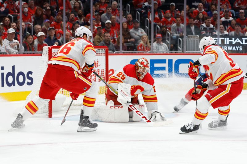 Oct 16, 2023; Washington, District of Columbia, USA; Calgary Flames goaltender Jacob Markstrom (25) covers the puck in front of Washington Capitals center Nicklas Backstrom (19) in the first period at Capital One Arena. Mandatory Credit: Geoff Burke-USA TODAY Sports