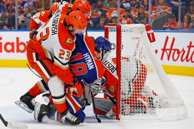 Jan 3, 2025; Edmonton, Alberta, CAN; Edmonton Oilers forward Zach Hyman (18) tries to jam the puck past Anaheim Ducks goaltender Lucas Dostal (1) during the first period at Rogers Place. Mandatory Credit: Perry Nelson-Imagn Images