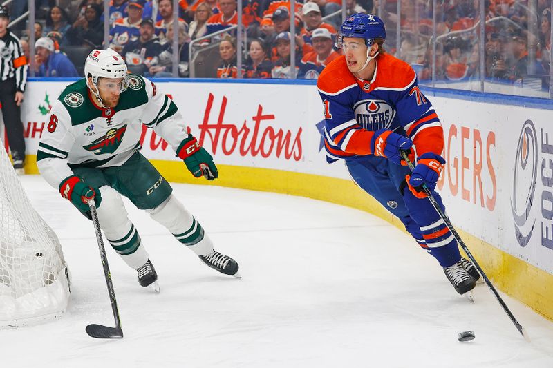 Dec 8, 2023; Edmonton, Alberta, CAN; Edmonton Oilers forward Ryan McLeod (71) looks to make a pass in front of Minnesota Wild defensemen Dakota Mermis (6) during the first period at Rogers Place. Mandatory Credit: Perry Nelson-USA TODAY Sports