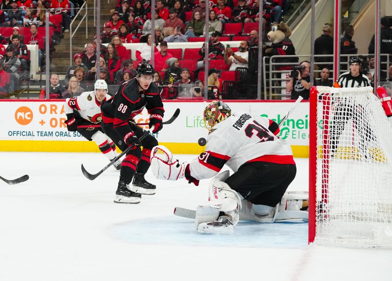 Nov 16, 2024; Raleigh, North Carolina, USA;  Carolina Hurricanes center Martin Necas (88) misses his scoring attempt against Ottawa Senators goaltender Anton Forsberg (31) during the first period at Lenovo Center. Mandatory Credit: James Guillory-Imagn Images