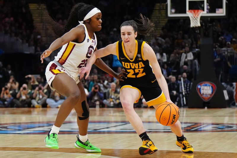 Apr 7, 2024; Cleveland, OH, USA; Iowa Hawkeyes guard Caitlin Clark (22) controls the ball against South Carolina Gamecocks guard Raven Johnson (25) in the first quarter in the finals of the Final Four of the womens 2024 NCAA Tournament at Rocket Mortgage FieldHouse. Mandatory Credit: Kirby Lee-USA TODAY Sports