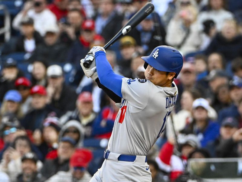 Apr 9, 2025; Washington, District of Columbia, USA; Los Angeles Dodgers two-way player Shohei Ohtani (17) singles against the Washington Nationals during the seventh inning at Nationals Park. Mandatory Credit: Brad Mills-Imagn Images