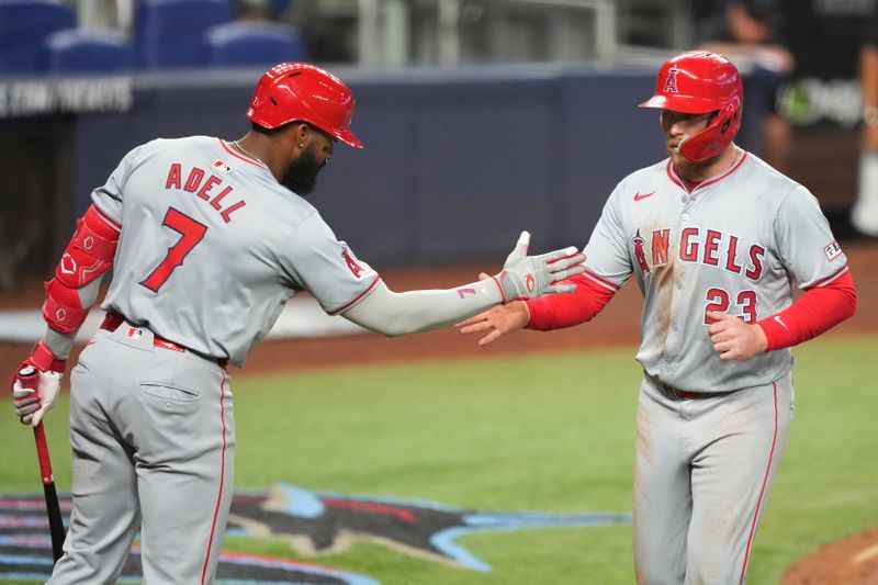 Apr 3, 2024; Miami, Florida, USA; Los Angeles Angels second baseman Brandon Drury (23) is congratulated by center fielder Jo Adell (7) after scoring a run in the fifth inning against the Miami Marlins at loanDepot Park. Mandatory Credit: Jim Rassol-USA TODAY Sports