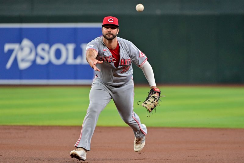 May 15, 2024; Phoenix, Arizona, USA; Cincinnati Reds first baseman Mike Ford (38) tosses the ball to first base in the third inning against the Arizona Diamondbacks at Chase Field. Mandatory Credit: Matt Kartozian-USA TODAY Sports