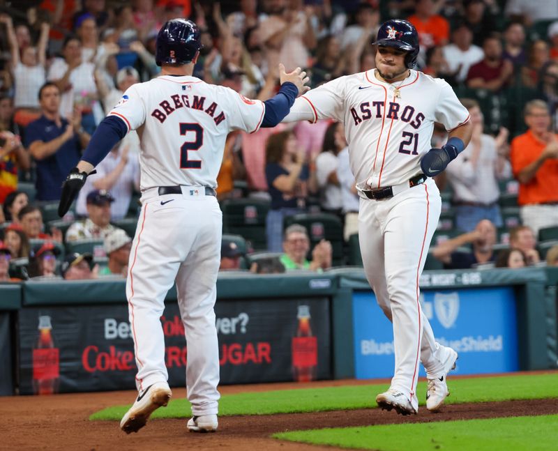 Jun 23, 2024; Houston, Texas, USA; Houston Astros third baseman Alex Bregman (2) celebrates scoring with  designated hitter Yainer Diaz (21) during the sixth inning against the Baltimore Orioles at Minute Maid Park. Mandatory Credit: Thomas Shea-USA TODAY Sports