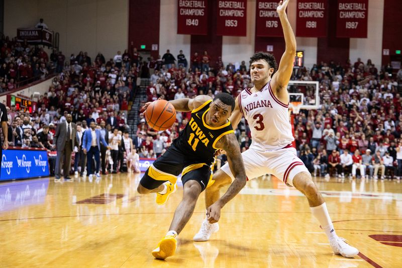 Jan 30, 2024; Bloomington, Indiana, USA; Iowa Hawkeyes guard Tony Perkins (11) dribbles the ball while Indiana Hoosiers guard Anthony Leal (3) defends in the second half at Simon Skjodt Assembly Hall. Mandatory Credit: Trevor Ruszkowski-USA TODAY Sports