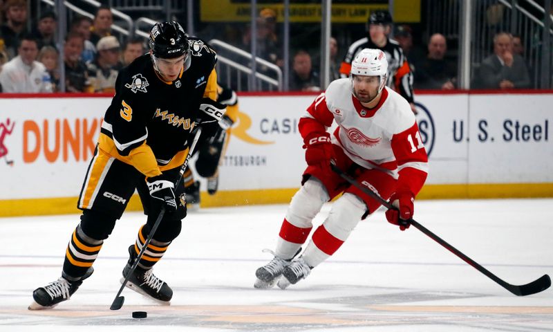 Apr 11, 2024; Pittsburgh, Pennsylvania, USA; Pittsburgh Penguins defenseman Jack St. Ivany (3) moves  the puck against Detroit Red Wings center Zach Aston-Reese (11) during the second period at PPG Paints Arena. Pittsburgh won 6-5 in overtime. Mandatory Credit: Charles LeClaire-USA TODAY Sports