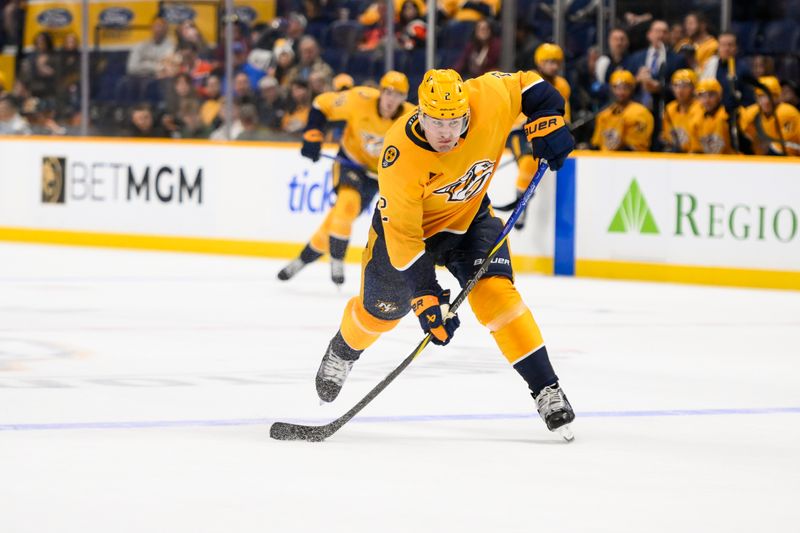 Oct 31, 2024; Nashville, Tennessee, USA;  Nashville Predators defenseman Luke Schenn (2) takes a shot on goal against the Edmonton Oilers during the third period at Bridgestone Arena. Mandatory Credit: Steve Roberts-Imagn Images