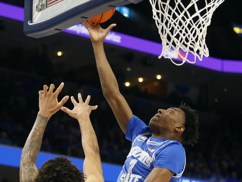 Mar 3, 2024; Memphis, Tennessee, USA; Memphis Tigers forward Nae'Qwan Tomlin (7) shoots as UAB Blazers forward Yaxel Lendeborg (3) defends during the first half at FedExForum. Mandatory Credit: Petre Thomas-USA TODAY Sports