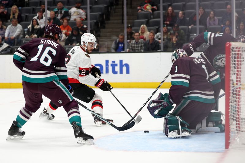 Mar 6, 2024; Anaheim, California, USA;  Ottawa Senators defenseman Artem Zub (2) fights for the puck against Anaheim Ducks goaltender Lukas Dostal (1) during the first period at Honda Center. Mandatory Credit: Kiyoshi Mio-USA TODAY Sports