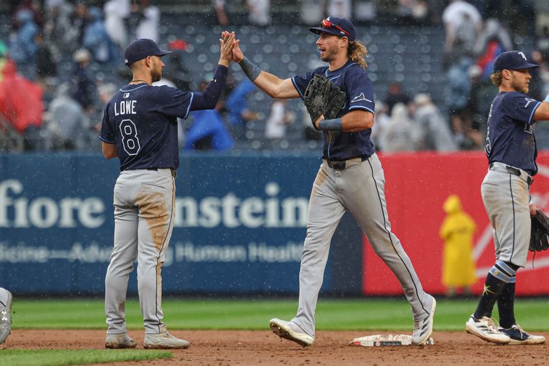 May 4, 2025; Bronx, New York, USA; Tampa Bay Rays right fielder Travis Jankowski (20) celebrates with second baseman Brandon Lowe (8) after defeating the New York Yankees at Yankee Stadium. Mandatory Credit: Vincent Carchietta-Imagn Images