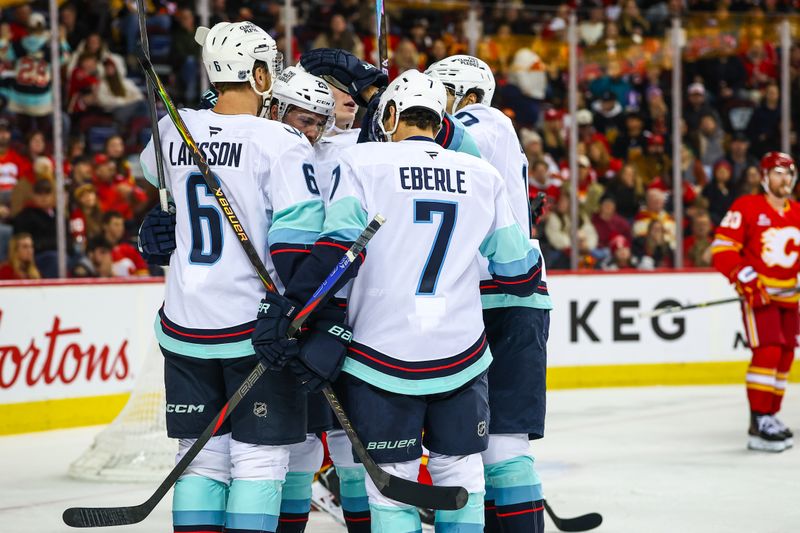 Jan 5, 2026; Calgary, Alberta, CAN; Seattle Kraken defenseman Vince Dunn (29) celebrates his goal with teammates against the Calgary Flames during the third period at Scotiabank Saddledome. Mandatory Credit: Sergei Belski-Imagn Images