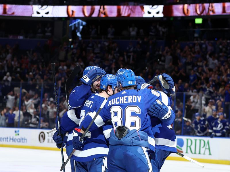 Jan 27, 2024; Tampa, Florida, USA; Tampa Bay Lightning center Brayden Point (21) is congratulated after he scored a goal against the New Jersey Devils during the third period at Amalie Arena. Mandatory Credit: Kim Klement Neitzel-USA TODAY Sports