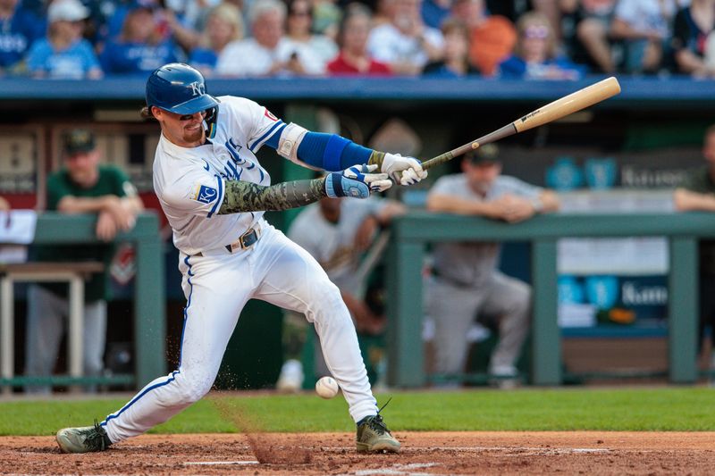 May 18, 2024; Kansas City, Missouri, USA; Kansas City Royals shortstop Bobby Witt Jr. (7) hits a short ball in front of the plate during the third inning against the Oakland Athletics at Kauffman Stadium. Mandatory Credit: William Purnell-USA TODAY Sports