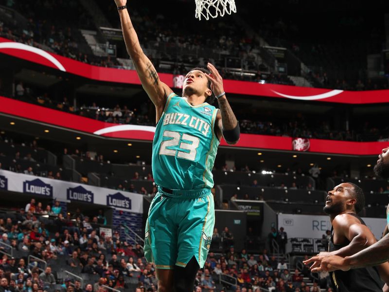 CHARLOTTE, NC - MARCH 27: Tre Mann #23 of the  Charlotte Hornets goes to the basket during the game on March 27, 2024 at Spectrum Center in Charlotte, North Carolina. NOTE TO USER: User expressly acknowledges and agrees that, by downloading and or using this photograph, User is consenting to the terms and conditions of the Getty Images License Agreement. Mandatory Copyright Notice: Copyright 2024 NBAE (Photo by Kent Smith/NBAE via Getty Images)