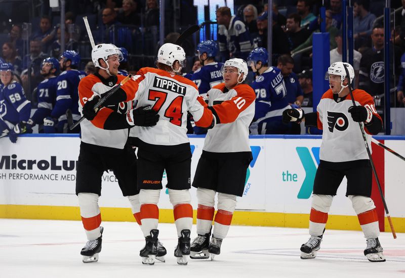 Nov 7, 2024; Tampa, Florida, USA; Philadelphia Flyers right wing Owen Tippett (74) is congratulated by defenseman Travis Sanheim (6) and right wing Bobby Brink (10) after scoring during the overtime shootout against the Tampa Bay Lightning at Amalie Arena. Mandatory Credit: Kim Klement Neitzel-Imagn Images