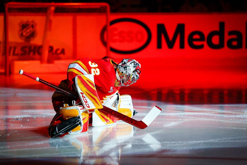 Nov 7, 2025; Calgary, Alberta, CAN; Calgary Flames goaltender Dustin Wolf (32) on the ice prior to the game between the Calgary Flames and the Chicago Blackhawks at Scotiabank Saddledome. Mandatory Credit: Sergei Belski-Imagn Images