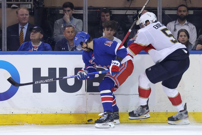 May 22, 2024; New York, New York, USA; New York Rangers left wing Artemi Panarin (10) and Florida Panthers defenseman Aaron Ekblad (5) fight for the puck during the third period of game one of the Eastern Conference Final of the 2024 Stanley Cup Playoffs at Madison Square Garden. Mandatory Credit: Brad Penner-USA TODAY Sports