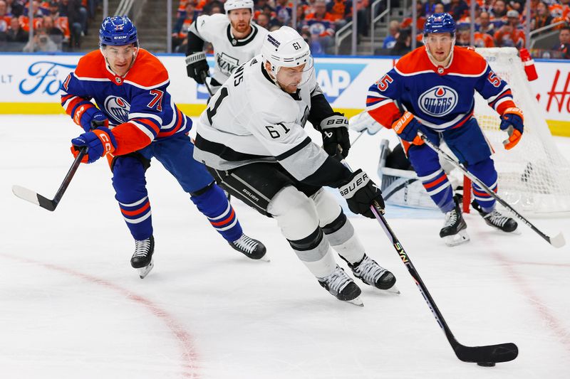 May 1, 2024; Edmonton, Alberta, CAN; Los Angeles Kings forward Trevor Lewis (61) tries to clear the puck in front of Edmonton Oilers forward Ryan McLeod (71) during the first period in game five of the first round of the 2024 Stanley Cup Playoffs at Rogers Place. Mandatory Credit: Perry Nelson-USA TODAY Sports