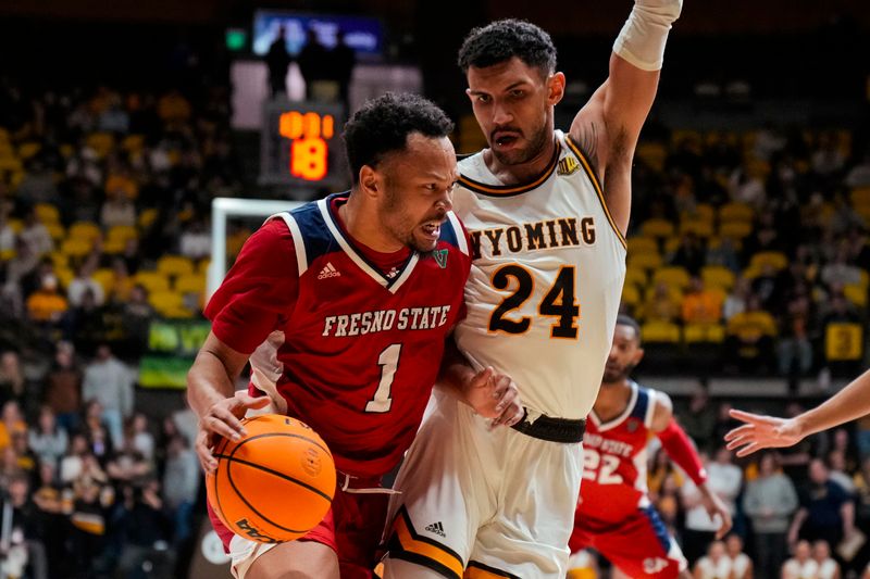 Jan 31, 2023; Laramie, Wyoming, USA; Fresno State Bulldogs guard Jemarl Baker (1) drives against Wyoming Cowboys guard Hunter Maldonado (24) during the first half at Arena-Auditorium. Mandatory Credit: Troy Babbitt-USA TODAY Sports